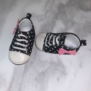 Gently used baby girls slip on shoes. Black with white hearts and bow. Size 3.
